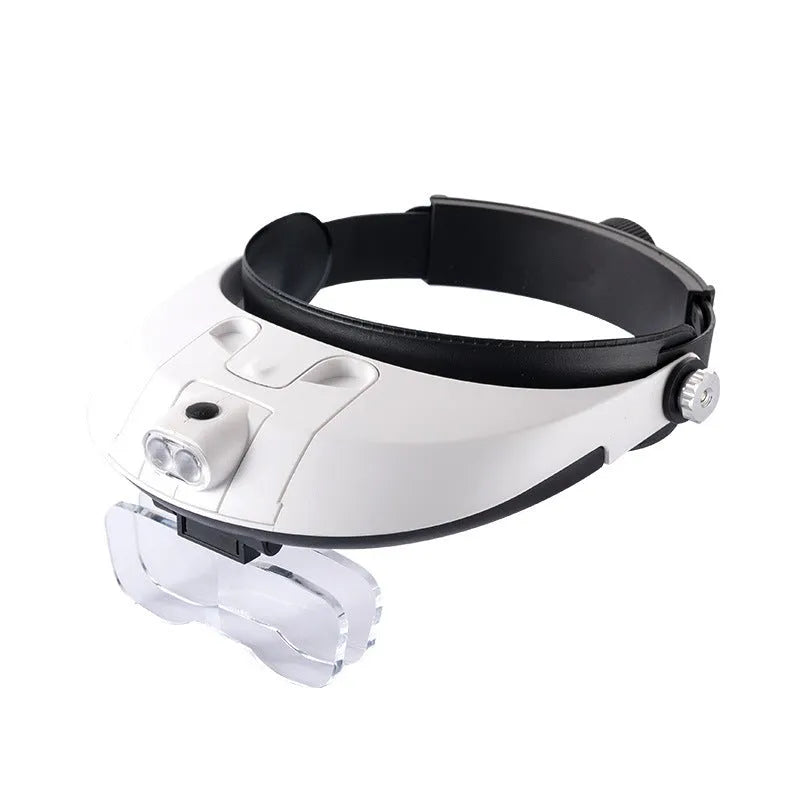 A person wearing a black LED headband magnifier with five acrylic lenses, using it for detailed hands-on repair work.