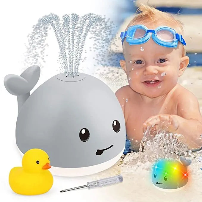 Grey or white cartoon whale bath toy that sprays water with LED lights and music