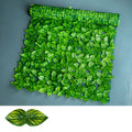 Artificial green plastic fence panel with printed leaves, used as a balcony privacy screen.