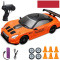 Huangbo red 4WD remote control drift car with wireless controller on a racing track