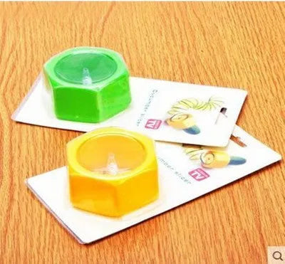 Yellow and green plastic spiral vegetable cutter for slicing cucumbers on a kitchen counter