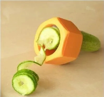 Yellow and green plastic spiral vegetable cutter for slicing cucumbers on a kitchen counter