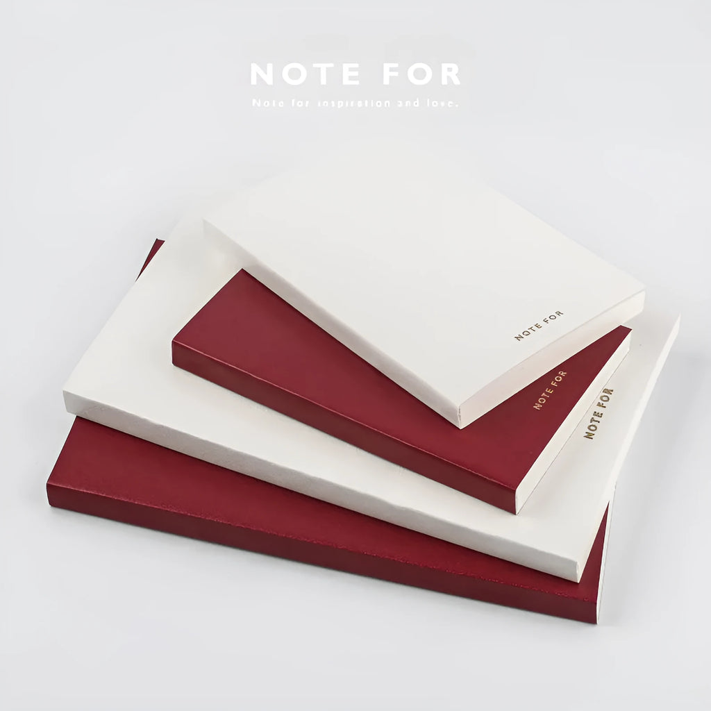 Red imitation leather hand book grid notebook showing inner core dot matrix pages with bronze detailing