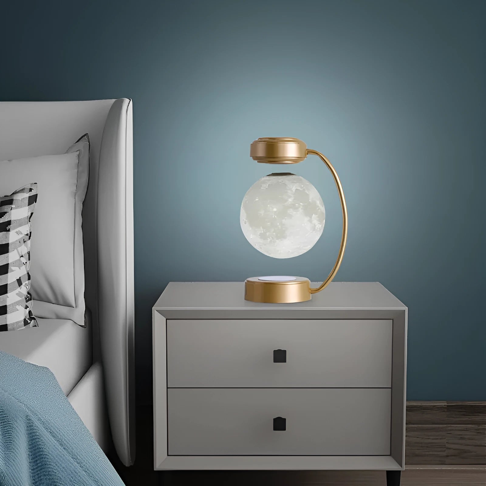 Black magnetic levitation moon lamp floating above base with touch control for bedside use