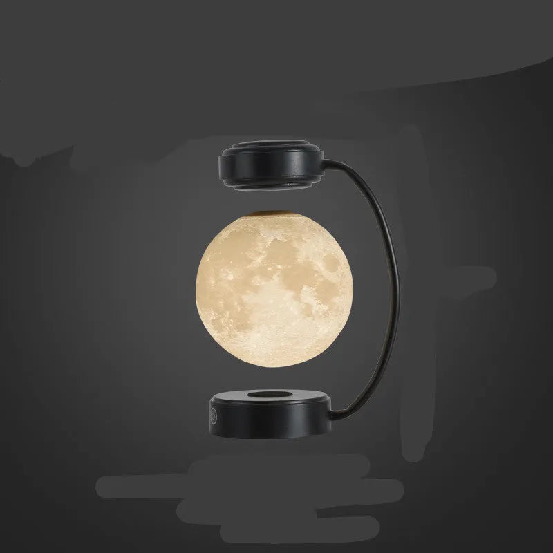 Black magnetic levitation moon lamp floating above base with touch control for bedside use