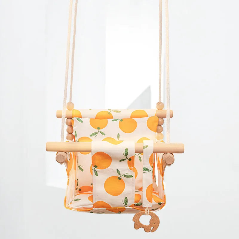 Natural cotton canvas baby swing chair with wooden seat and cushion hanging indoors