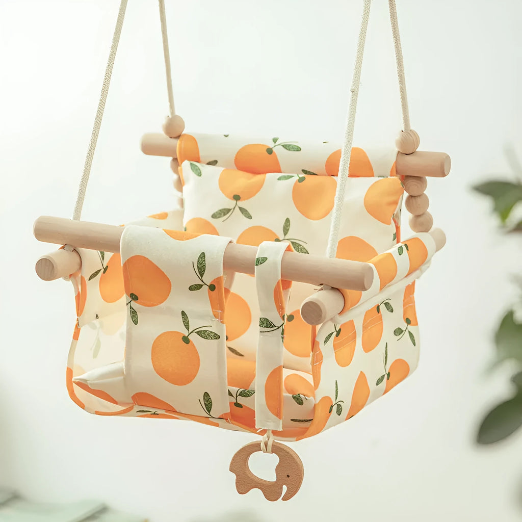 Natural cotton canvas baby swing chair with wooden seat and cushion hanging indoors