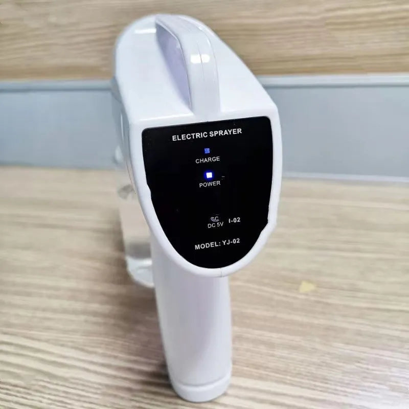 White handheld cordless electric spray disinfection gun with USB charging cable