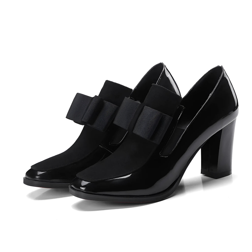 Women's black patent leather high-heel shoes with a thick heel and square toe.