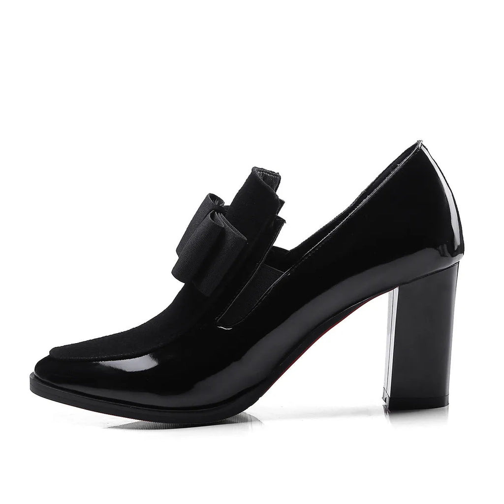 Women's black patent leather high-heel shoes with a thick heel and square toe.