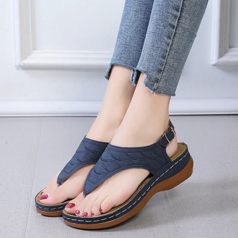 Women's black casual wedge heel sandals with an adjustable buckle strap on ankle.