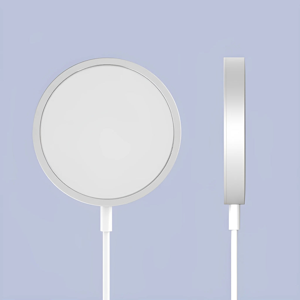 Silver metal Magsafe wireless charger for Apple iPhone on a table.