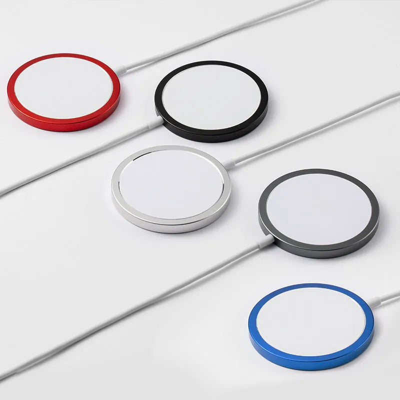 Silver metal Magsafe wireless charger for Apple iPhone on a table.