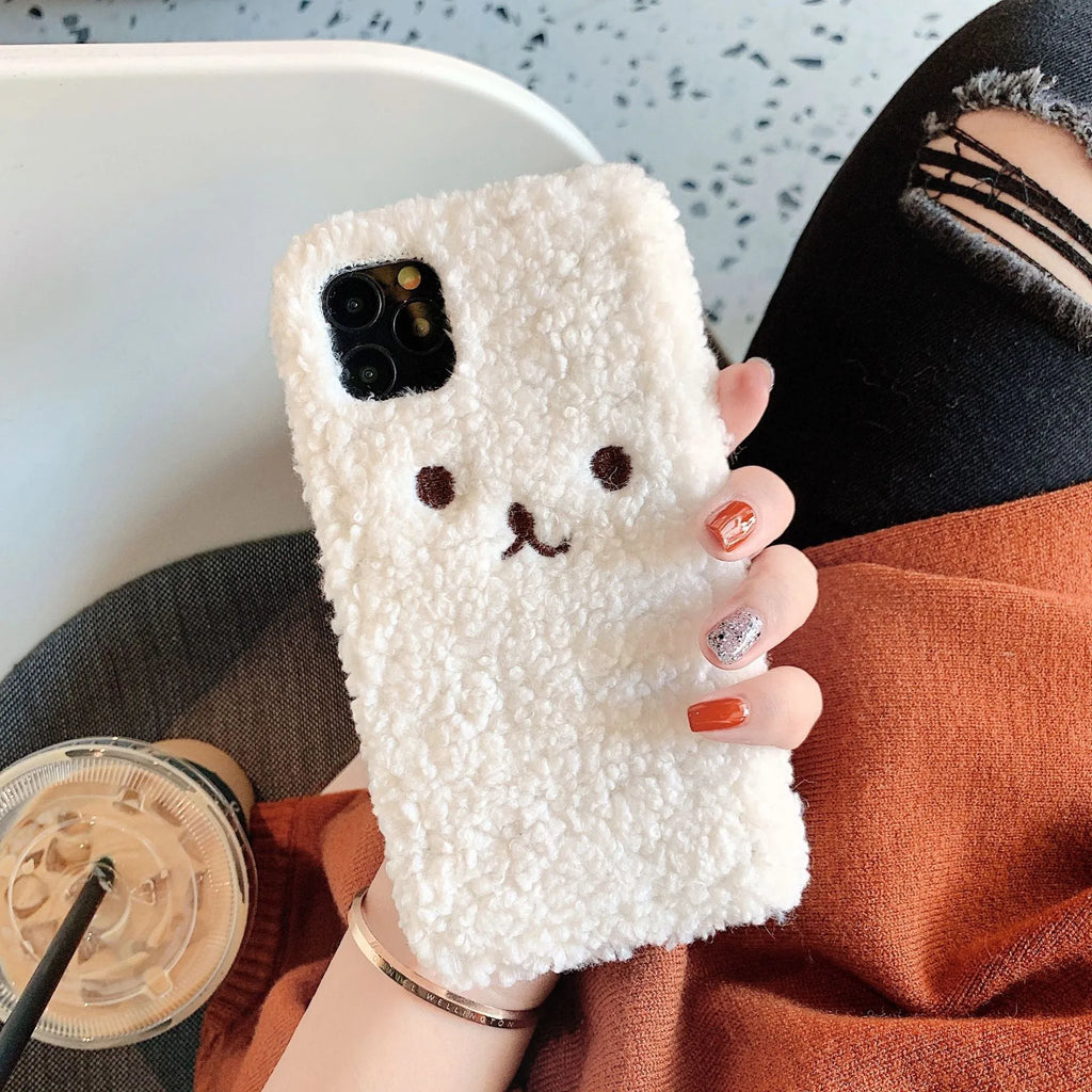 Brown soft TPU iPhone case featuring a raised plush bear face with embroidered details.