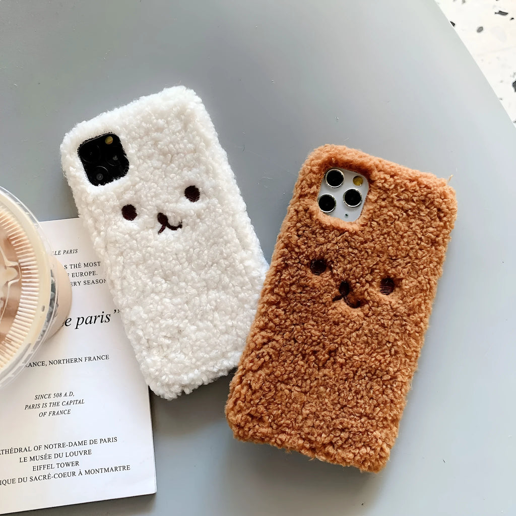 Brown soft TPU iPhone case featuring a raised plush bear face with embroidered details.