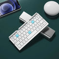 Aluminium foldable Bluetooth keyboard open with phone propped on stand and closed for pocket storage