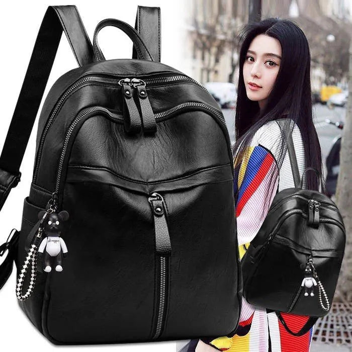 Black Pu leather backpack with soft surface, dual straps, and a large main compartment.