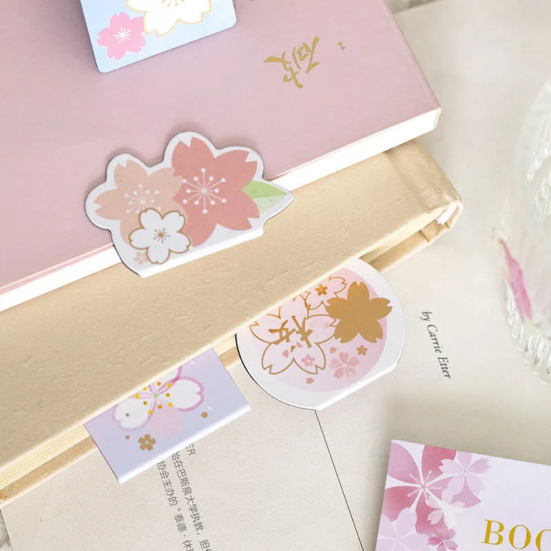 Set of four Yanji cherry blossom magnetic bookmarks showing different sakura designs.