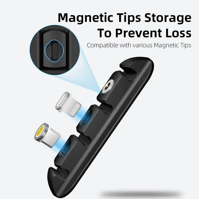 Black soft plastic magnetic desktop charging cable organiser on a desk.