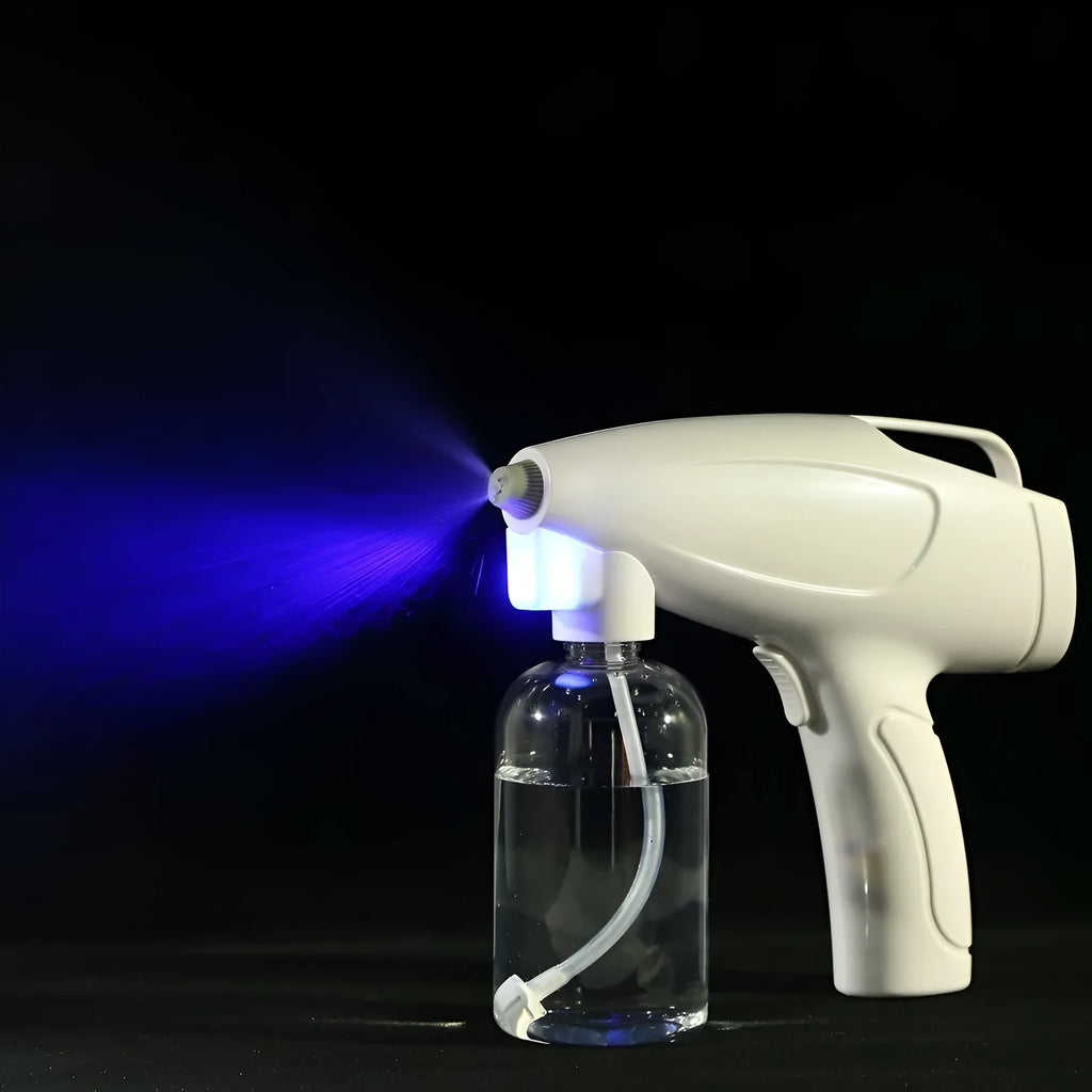 White handheld cordless electric spray disinfection gun with USB charging cable
