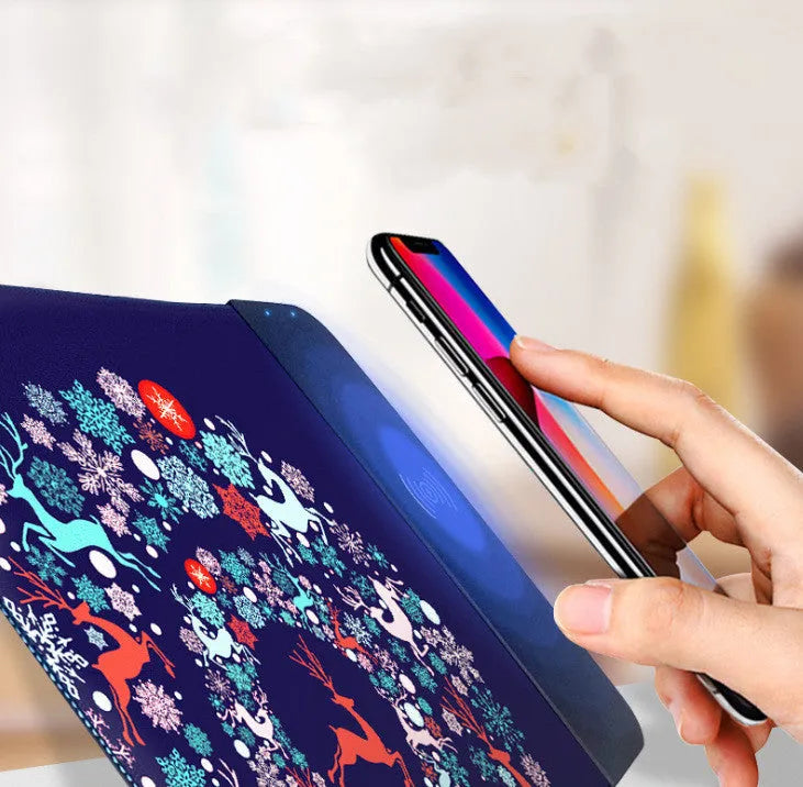 Wireless charging mouse pad with RGB lighting and cartoon design on black cloth surface