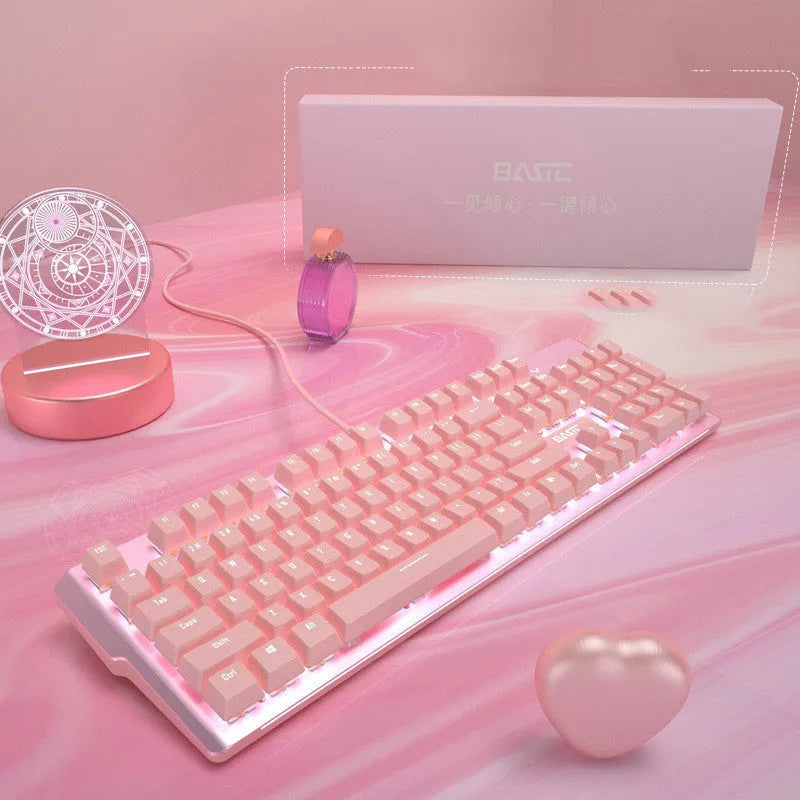 Pink wired mechanical keyboard and matching mouse for PC gaming on a desk.