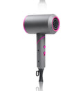 Foldable hair dryer in dark green with gold trim, showing concentrator nozzle and diffuser attachment.