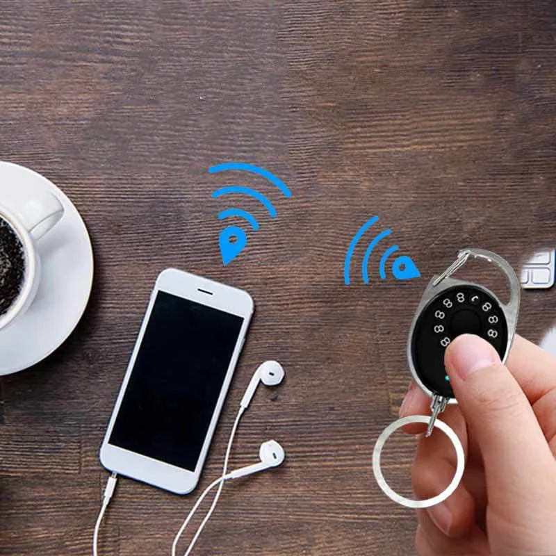 Black Bluetooth tracker keychain compatible with Apple Find My network, showing compact design.