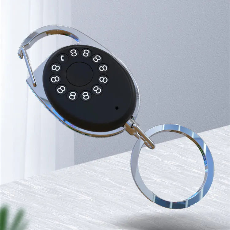 Black Bluetooth tracker keychain compatible with Apple Find My network, showing compact design.