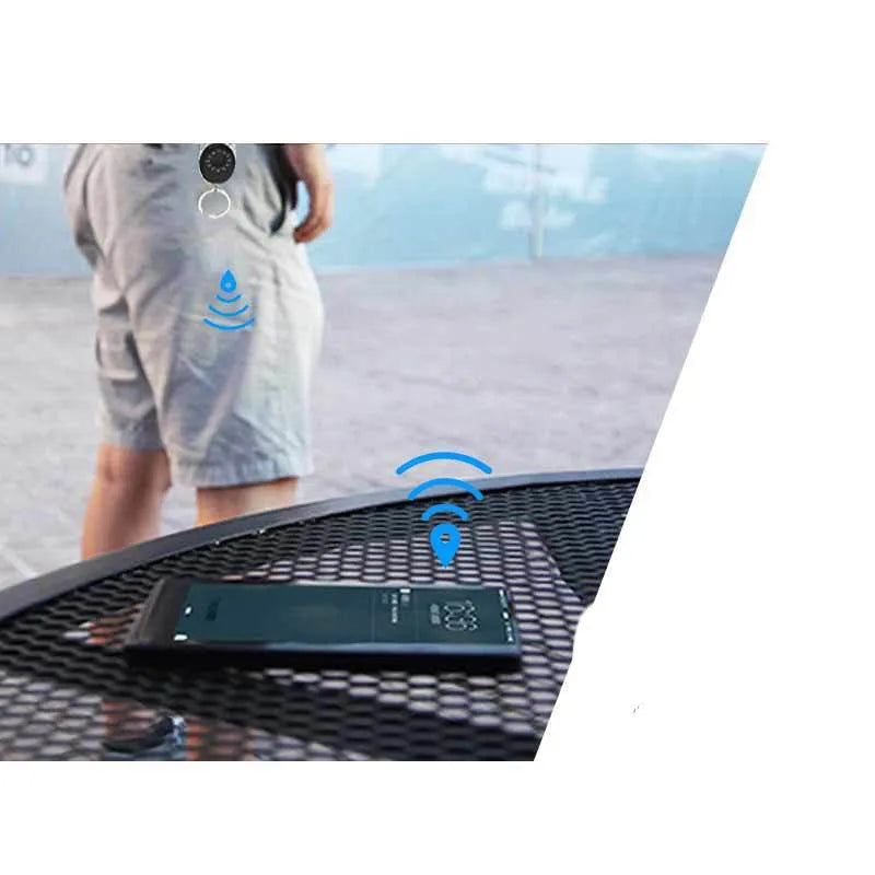 Black Bluetooth tracker keychain compatible with Apple Find My network, showing compact design.