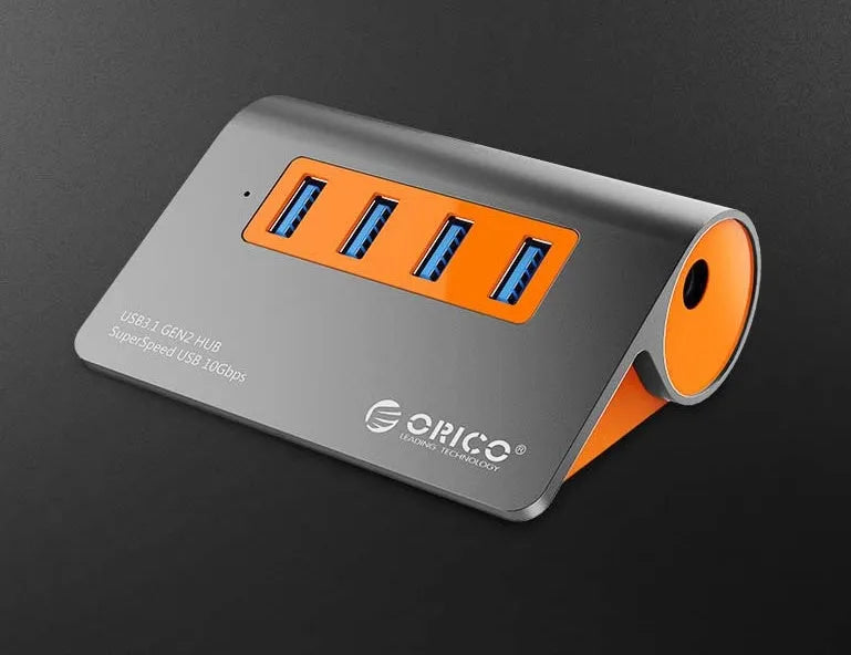 Dark grey and orange aluminium USB-C hub with four USB ports, a blue LED light, and a separate data cable.