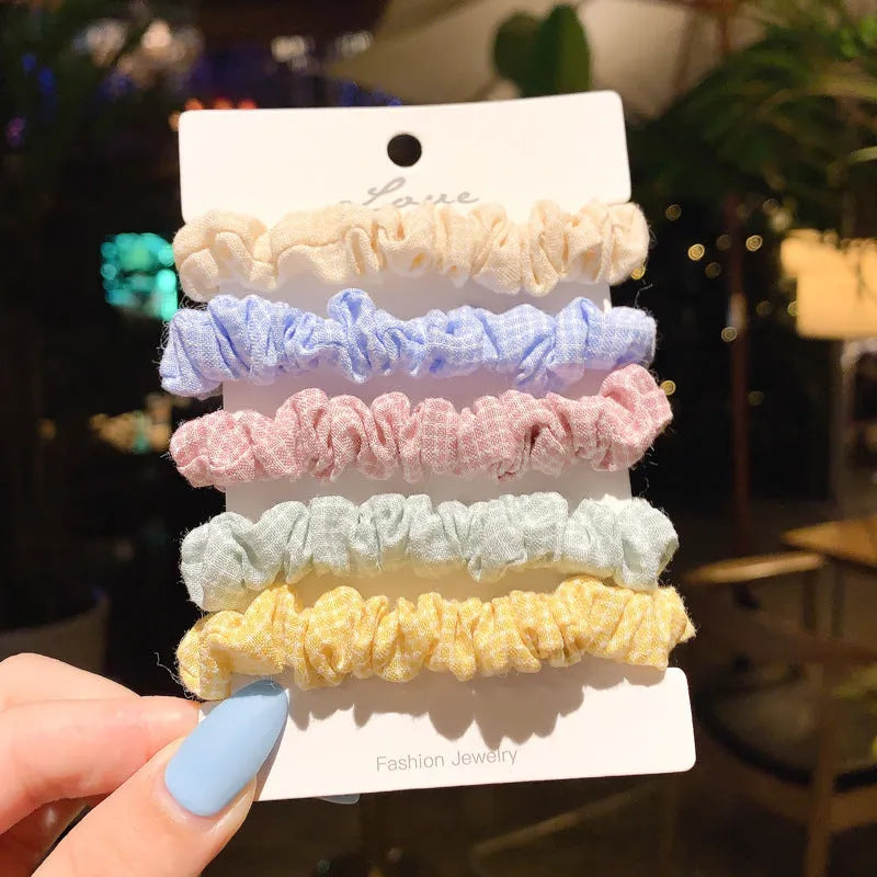 Assorted children's hair rings and head ropes in autumn colours and macaron pastels.