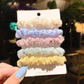 Assorted children's hair rings and head ropes in autumn colours and macaron pastels.