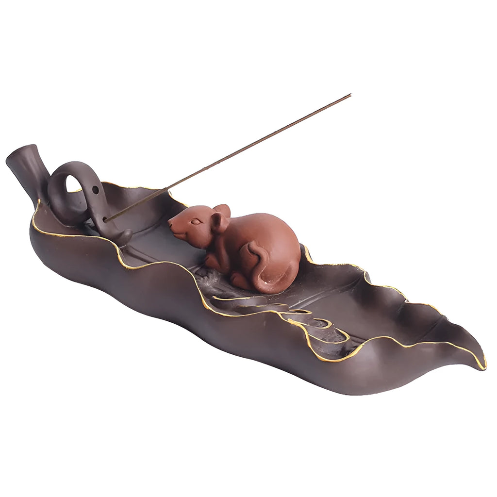 Purple clay ceramic lying incense burner with golden rat design holds incense stick