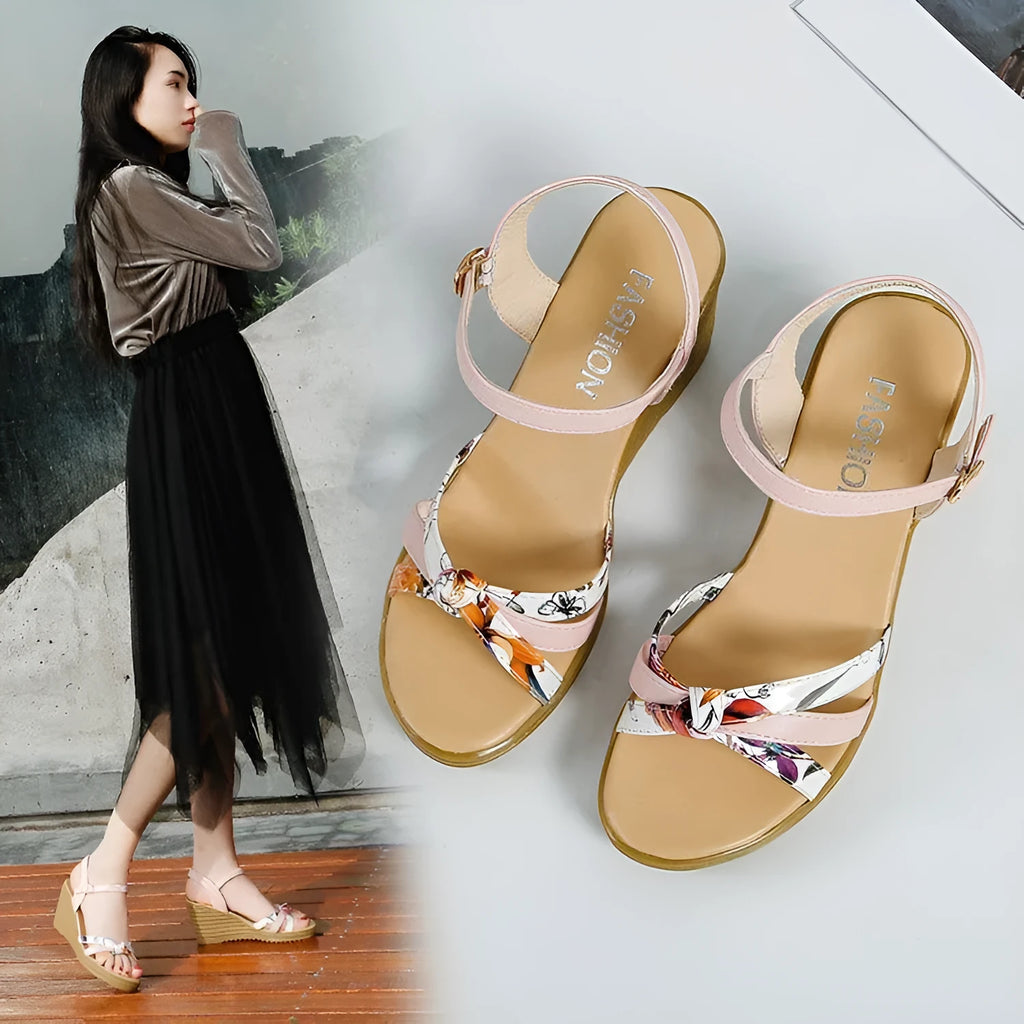 Pink and white women's wedge sandals with a buckle and non-slip platform sole.