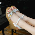 Pink and white women's wedge sandals with a buckle and non-slip platform sole.