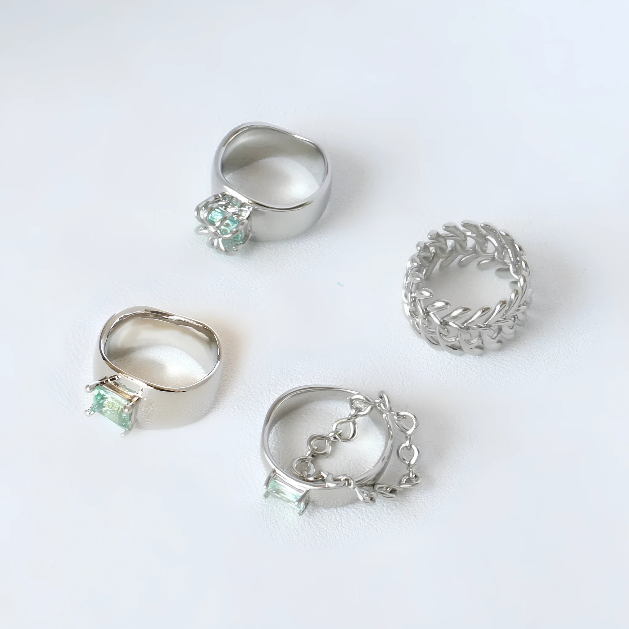 Copper platinum plated couple ring with three-ring gem design in style A on a neutral background
