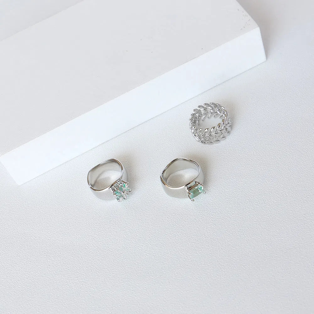 Copper platinum plated couple ring with three-ring gem design in style A on a neutral background