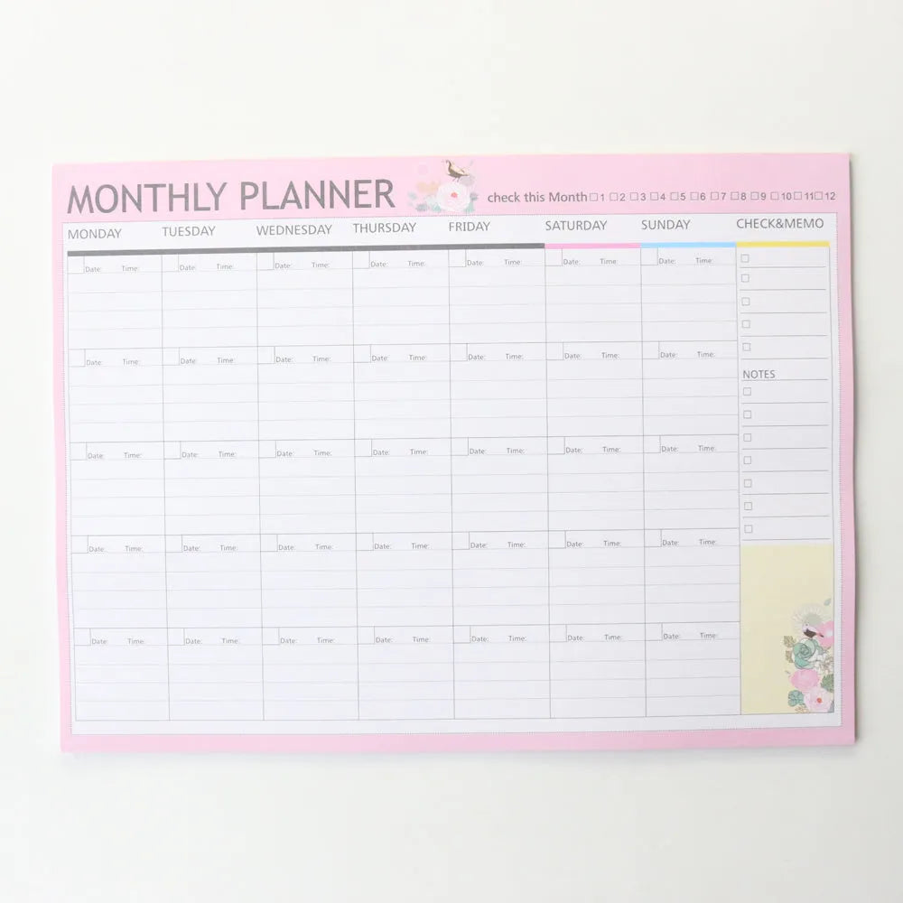 Domikee pink and green paper desk organiser planner notebook open on a desk.