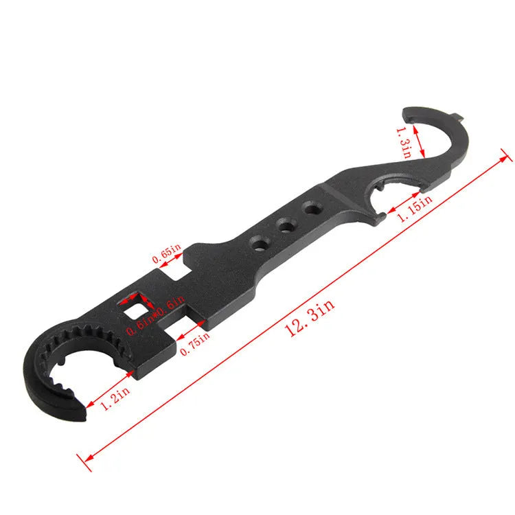 Black all-steel dual-purpose combination wrench for AR-15 and M4 rifle maintenance on a workshop bench.