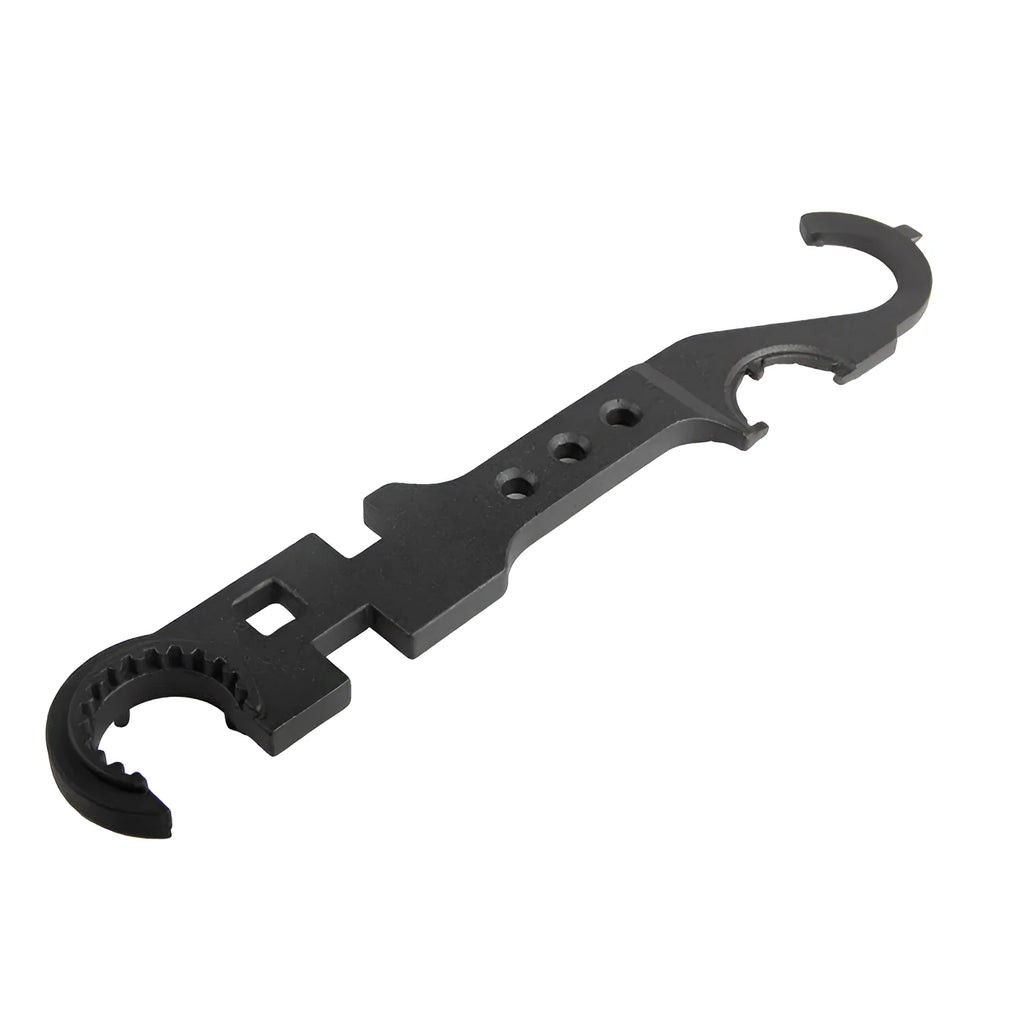 Black all-steel dual-purpose combination wrench for AR-15 and M4 rifle maintenance on a workshop bench.
