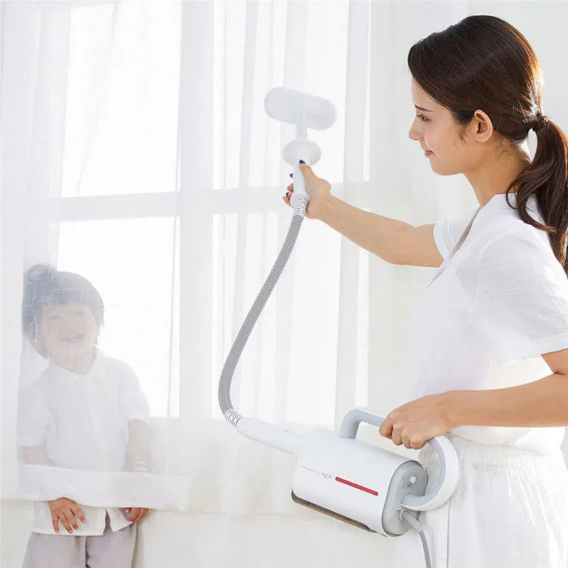 Deerma DEM-ZQ610 white steam cleaner unit with assorted brush heads including a glass scraper and mop.