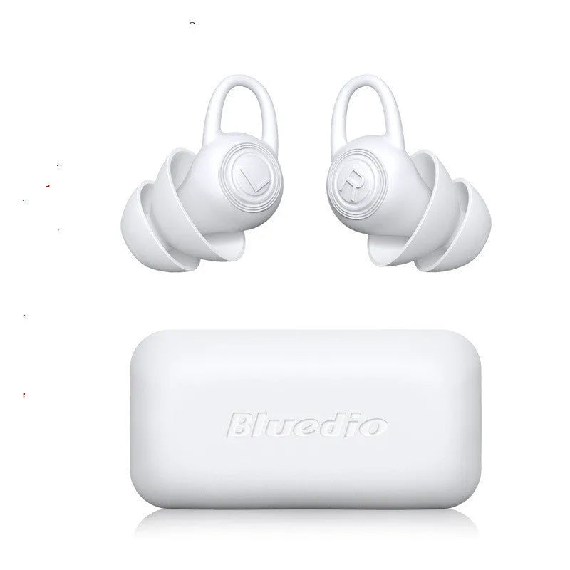 A pair of white soft silicone ear plugs for noise reduction on a clean background.