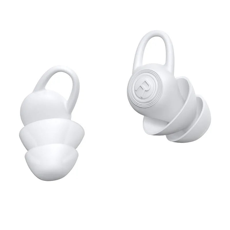 A pair of white soft silicone ear plugs for noise reduction on a clean background.
