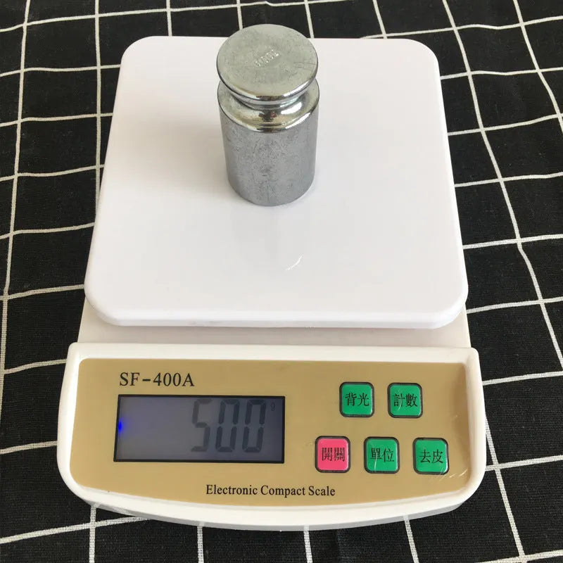 SF-400A black digital kitchen scale on a countertop showing a weight reading.