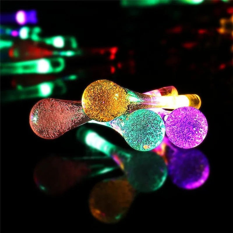 Solar-powered outdoor LED string lights with water drop shaped pendants on a 6.5 metre cable.