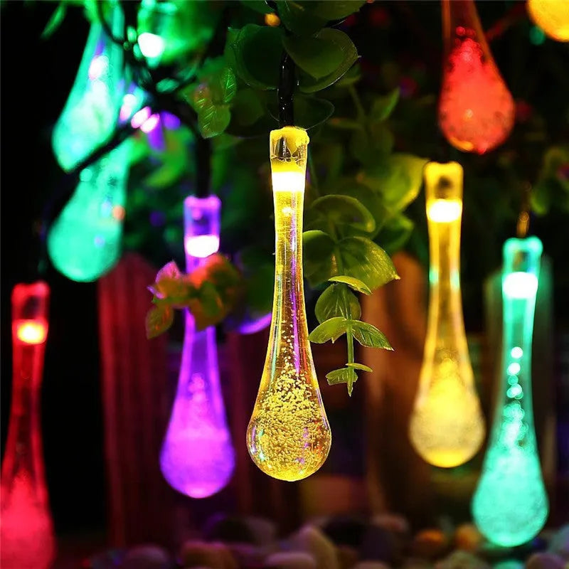 Solar-powered outdoor LED string lights with water drop shaped pendants on a 6.5 metre cable.