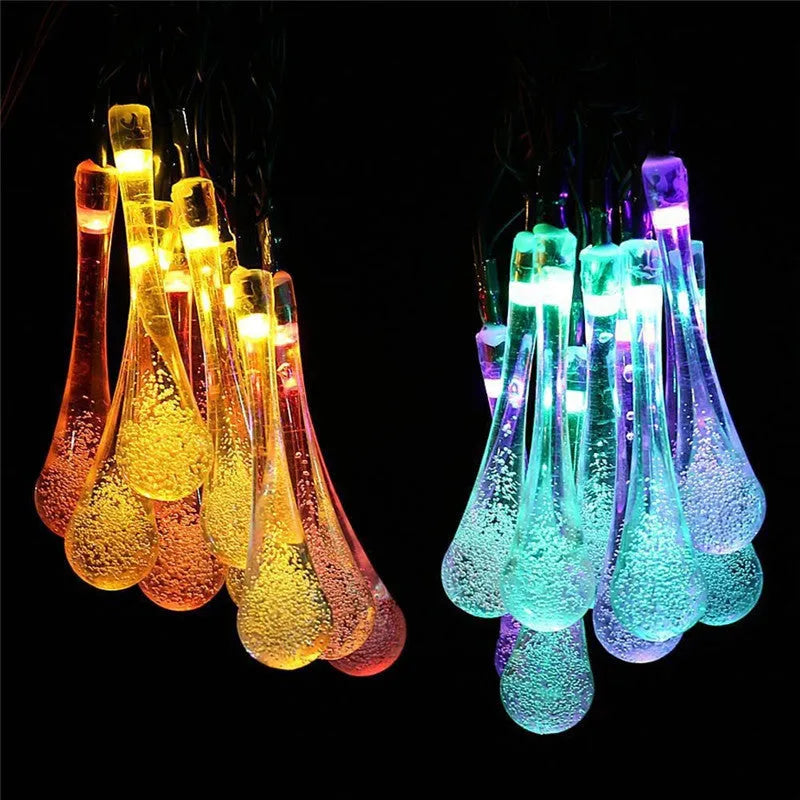 Solar-powered outdoor LED string lights with water drop shaped pendants on a 6.5 metre cable.