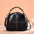 Round leather handbag with zip and soft handles in wine red colour
