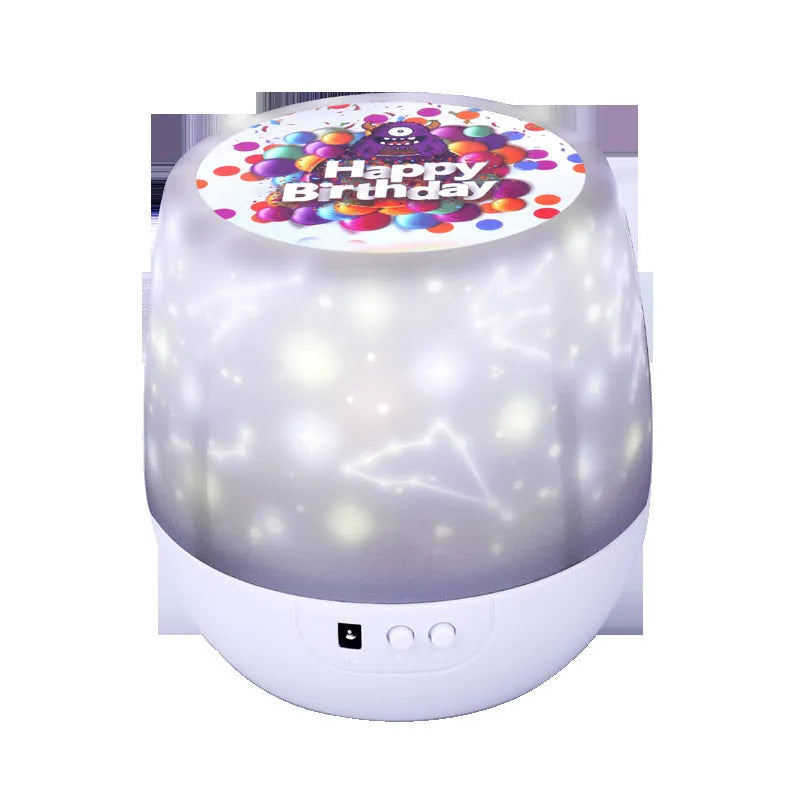 Compact cartoon-style starry sky projector lamp projecting cosmic imagery on a dark wall.